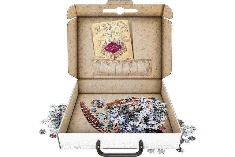 Jigsaw puzzle in an open box with a decorative cover on a white background